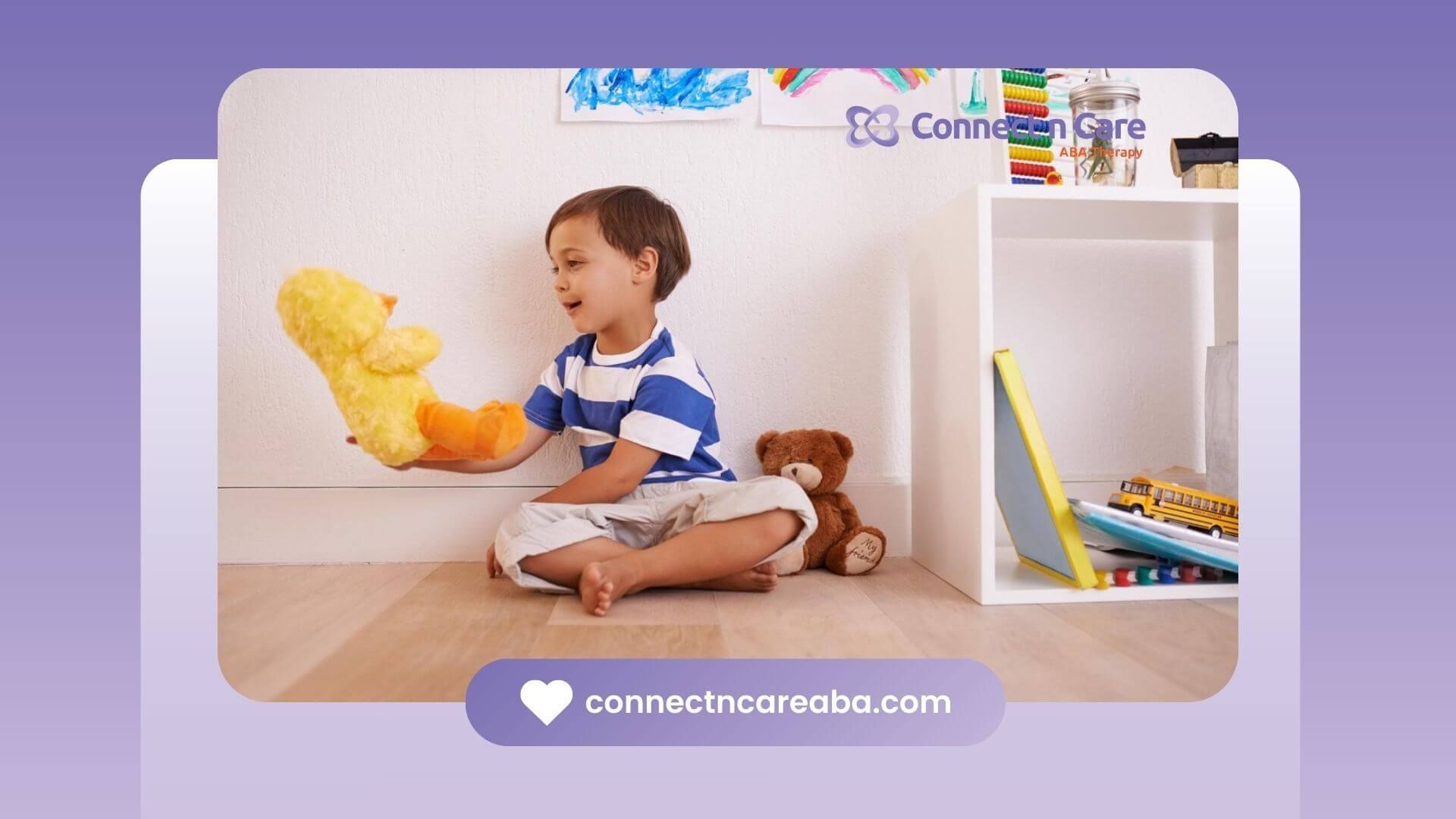 Child with autism sitting on the floor playing with a yellow stuffed duck near a toy shelf.
