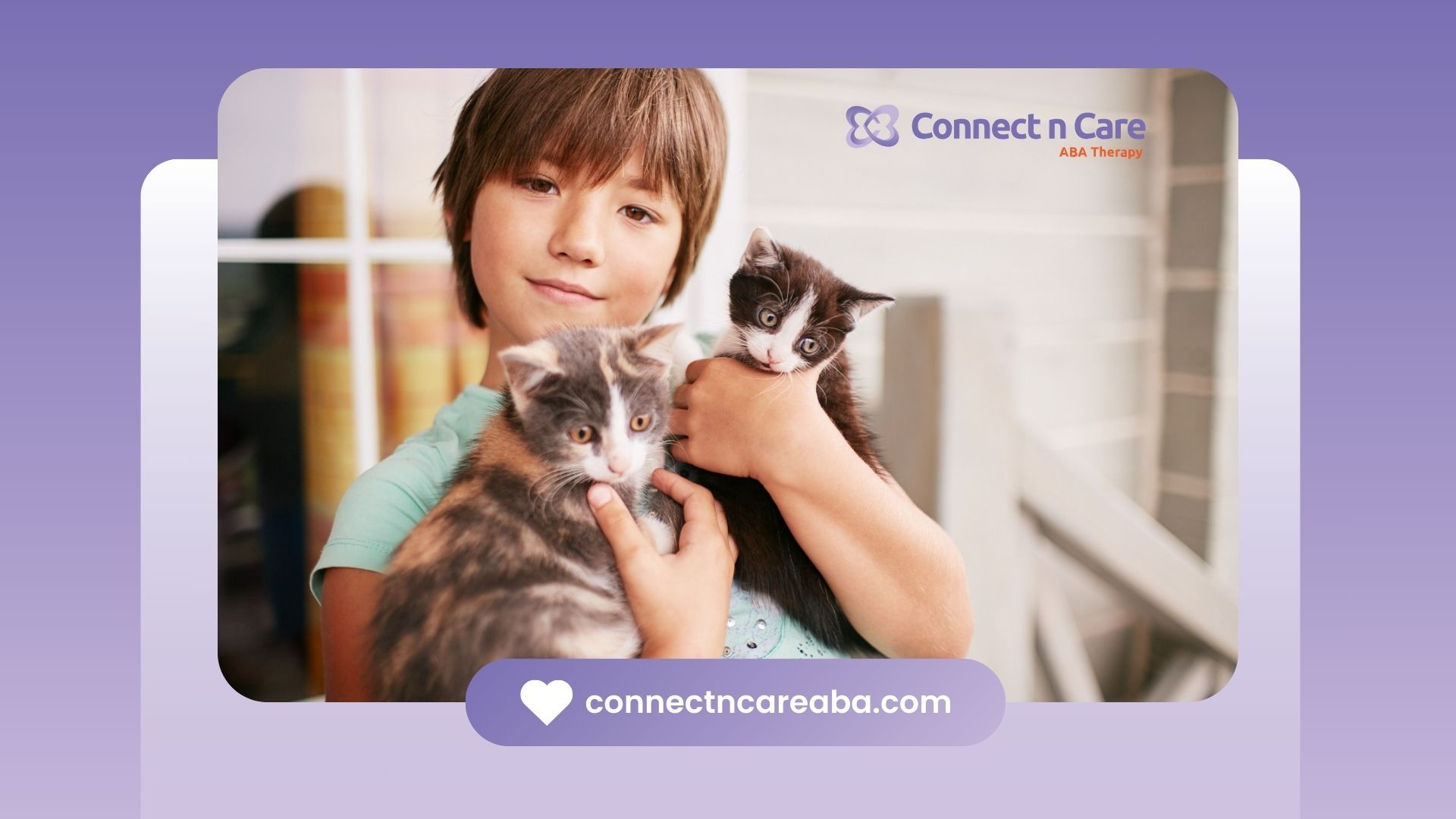 A young boy is holding two kittens in his arms.