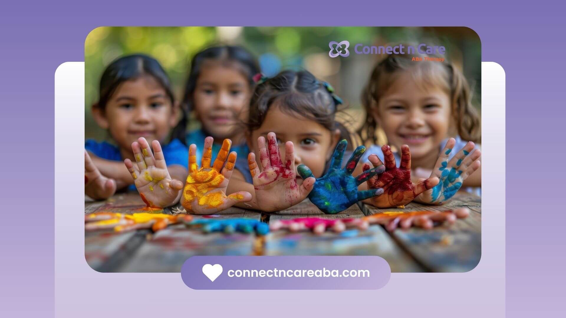 Colorful handprints of four autistic children with paint on a wooden table after ABA therapy.