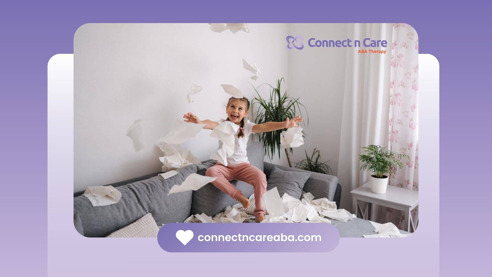 Young girl joyfully tossing tissues in the air while sitting on a couch at home.