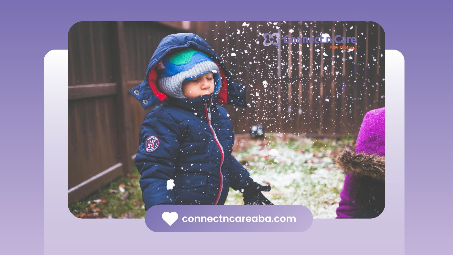 An autistic young boy bundled in winter clothes focused on playing with snow in North Carolina.