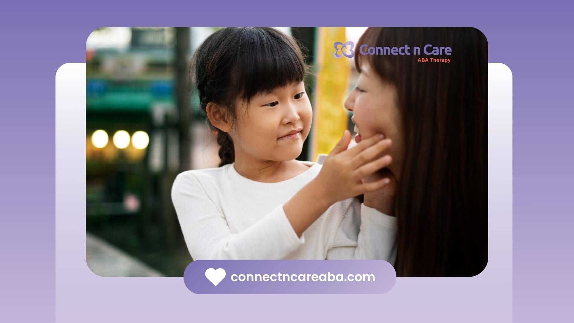 A little girl is putting her hand on a BCBA's face.
