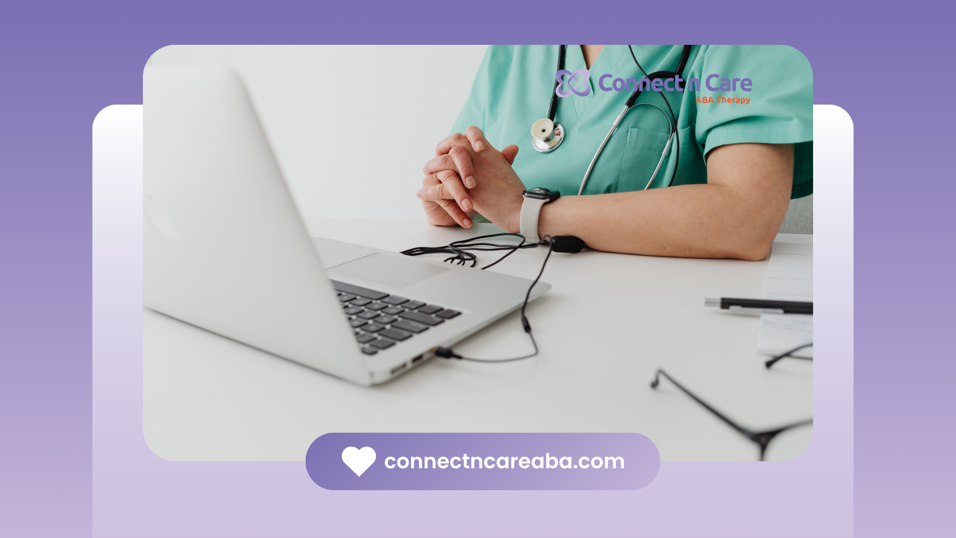 A nurse is sitting at a desk using a laptop computer.