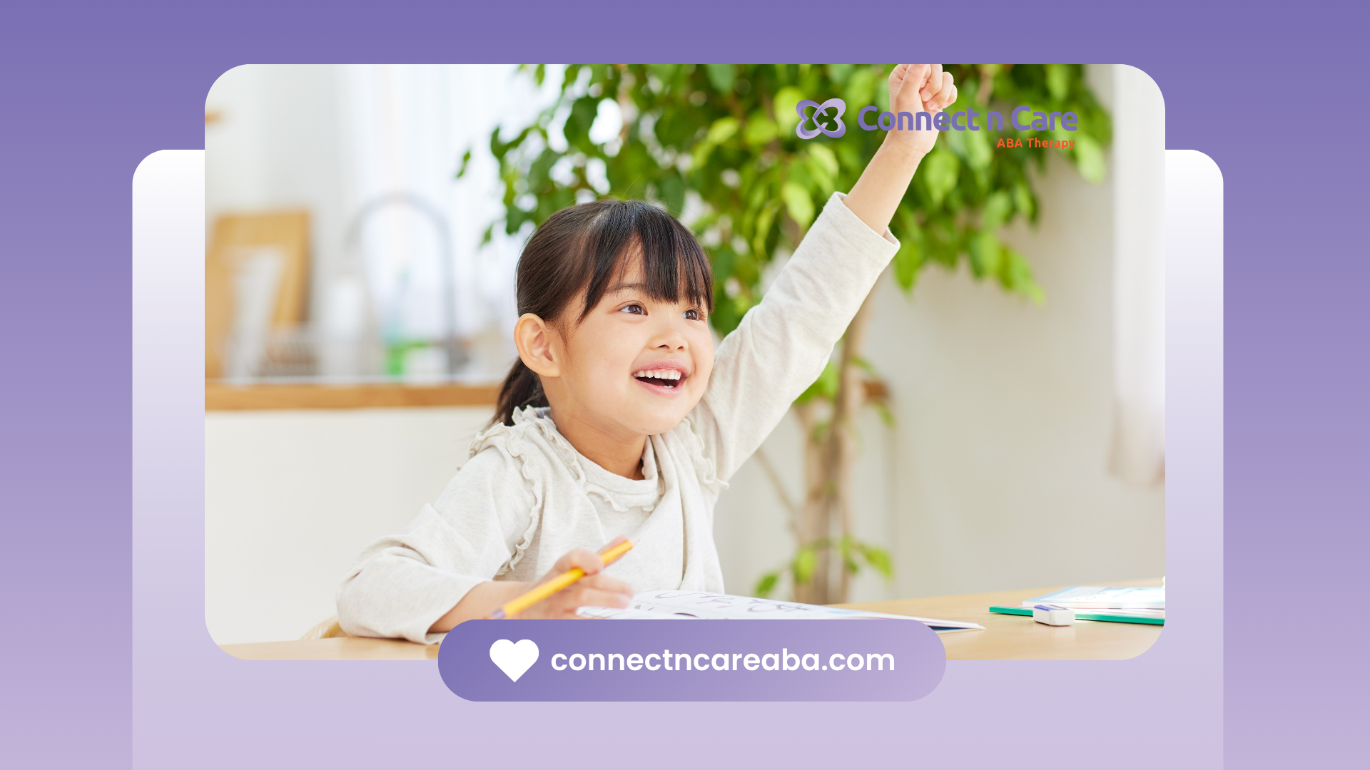 Girl raises hand excitedly in a classroom, smiling, with a pencil in hand.