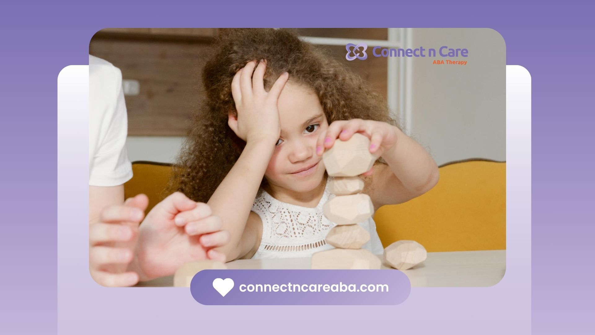An autistic girl is stacking blocks while holding her head during school-based ABA therapy in NC.