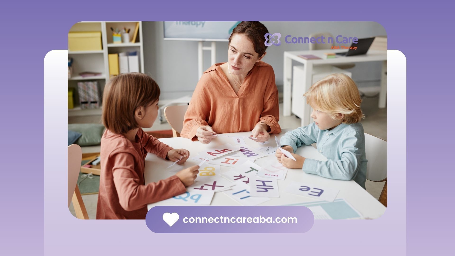 A woman is sitting at a table with two children.