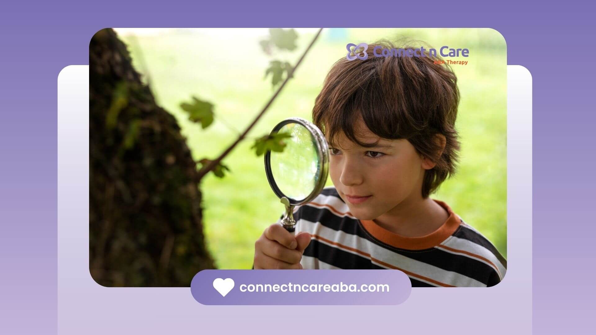 A boy with autism examining a tree branch with a magnifying glass outdoors.