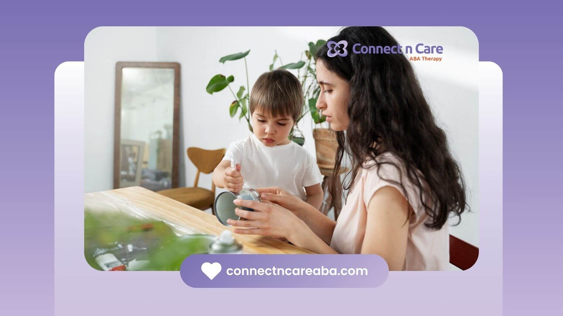 A BCBA is sitting at a table with a child in ABA therapy.