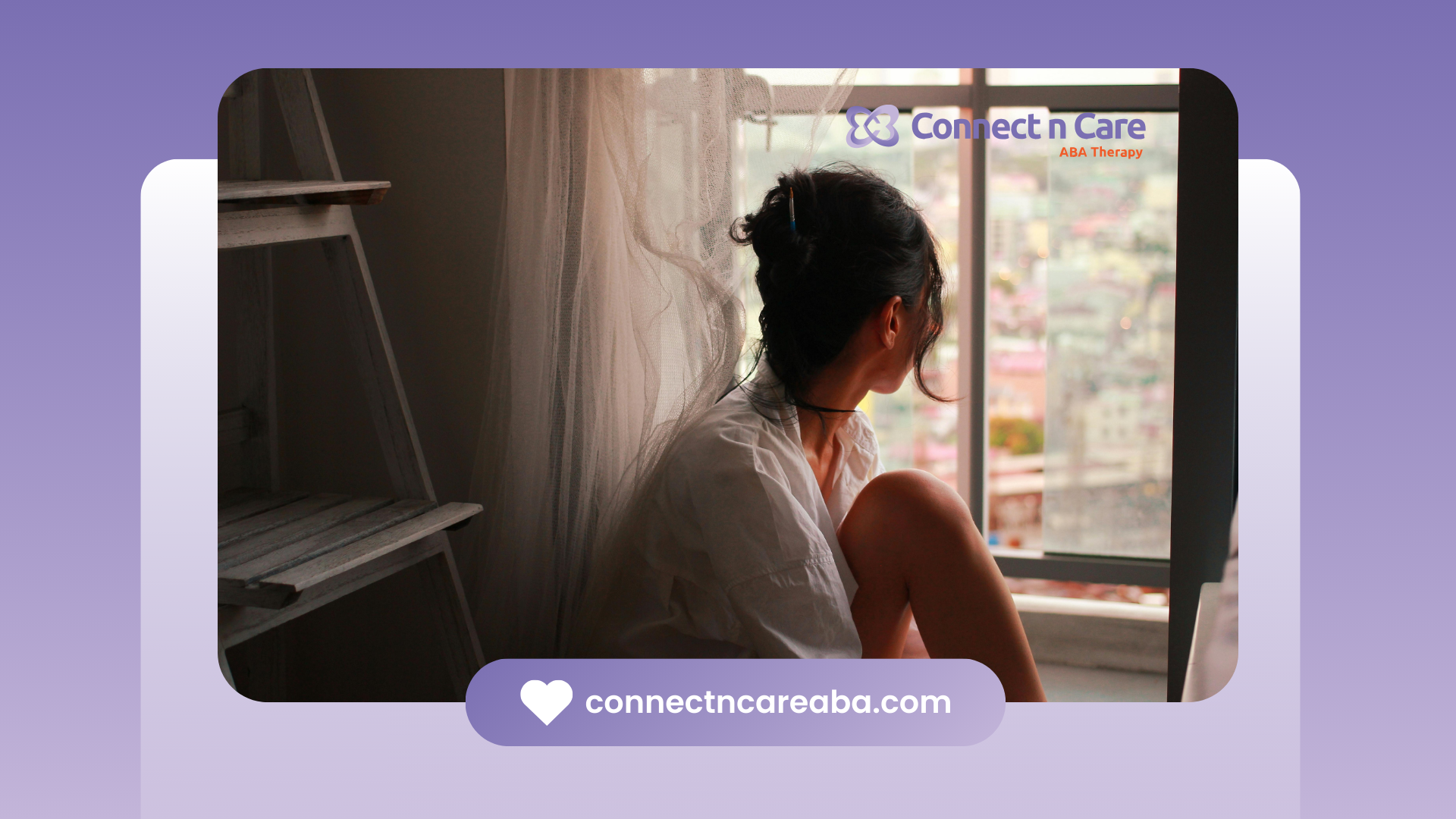 Woman sitting by a window, looking outside, inside a room.
