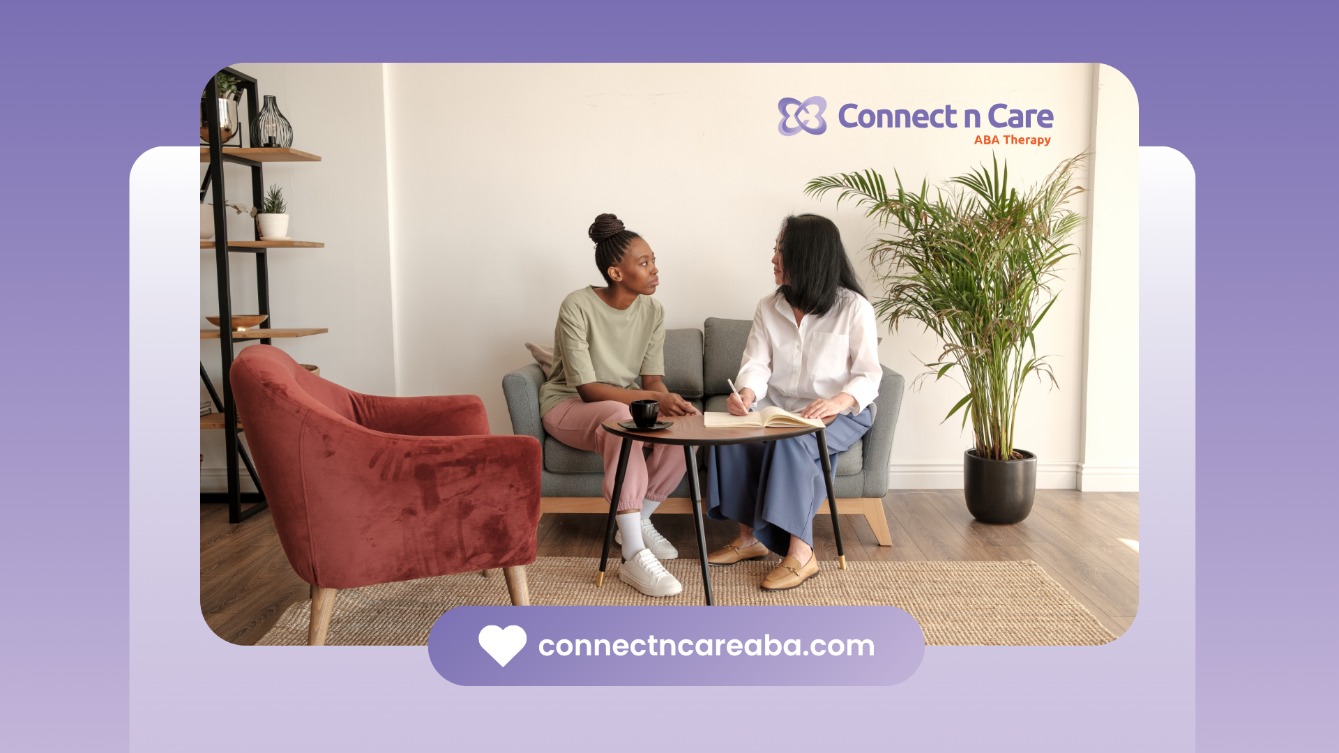 Two women are sitting on a couch talking to each other in a living room.