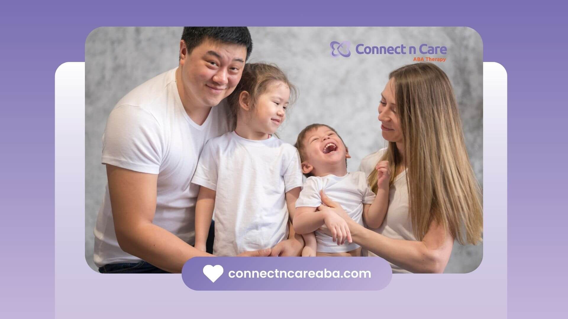 A family laughing and posing in matching white t-shirts, with the parents holding their kids.