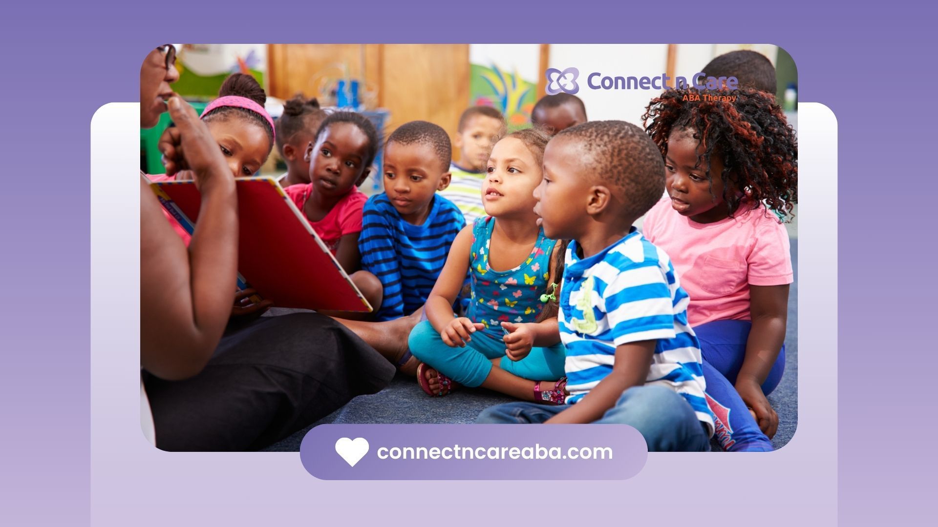 A woman is reading a book to a group of children.