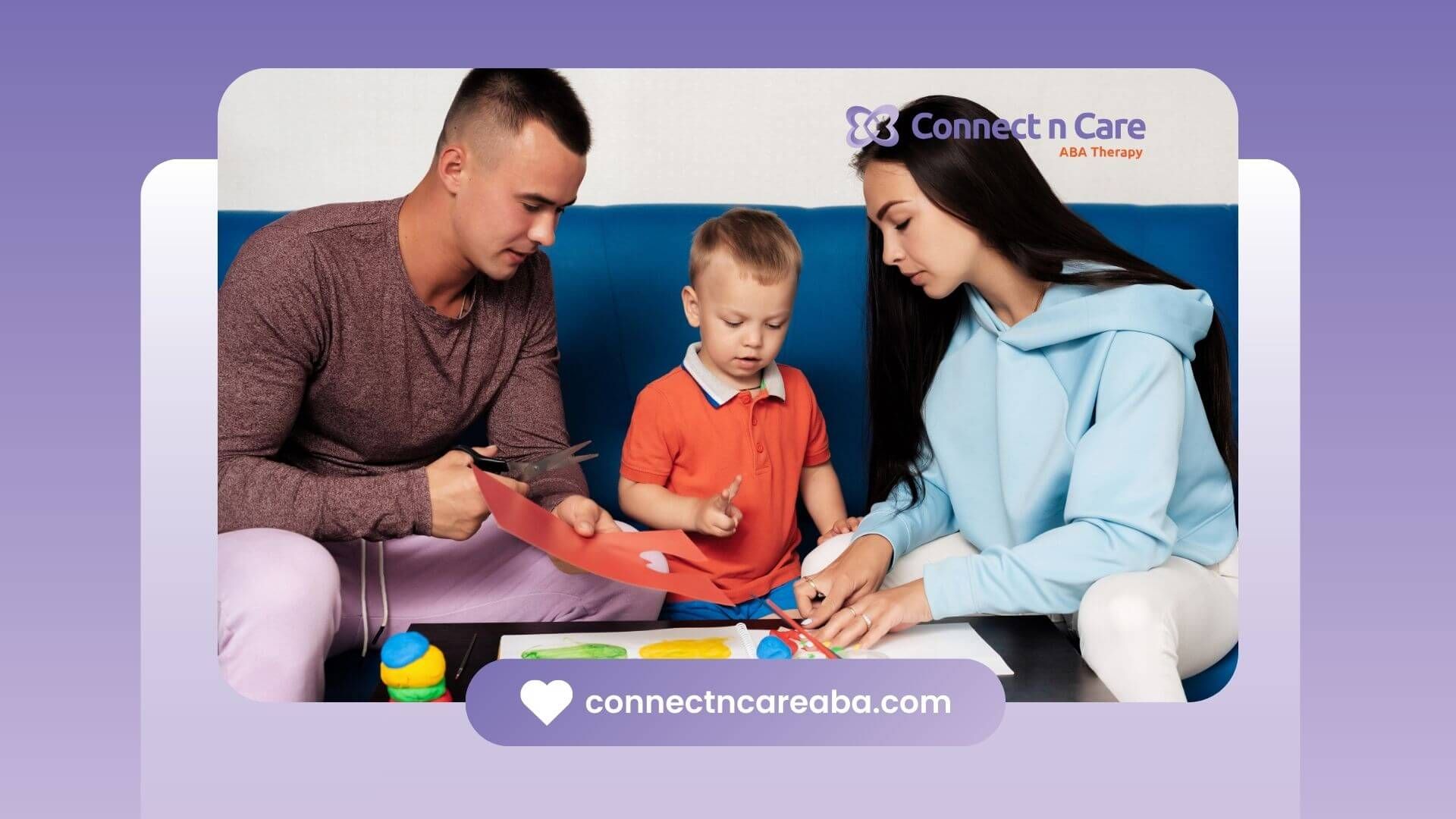 Parents and child working on an art project together, cutting paper and drawing during therapy.