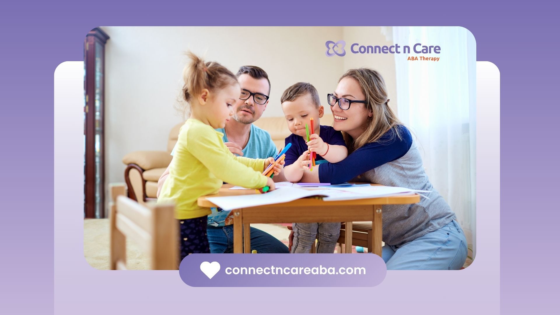 A family is sitting at a table drawing together.