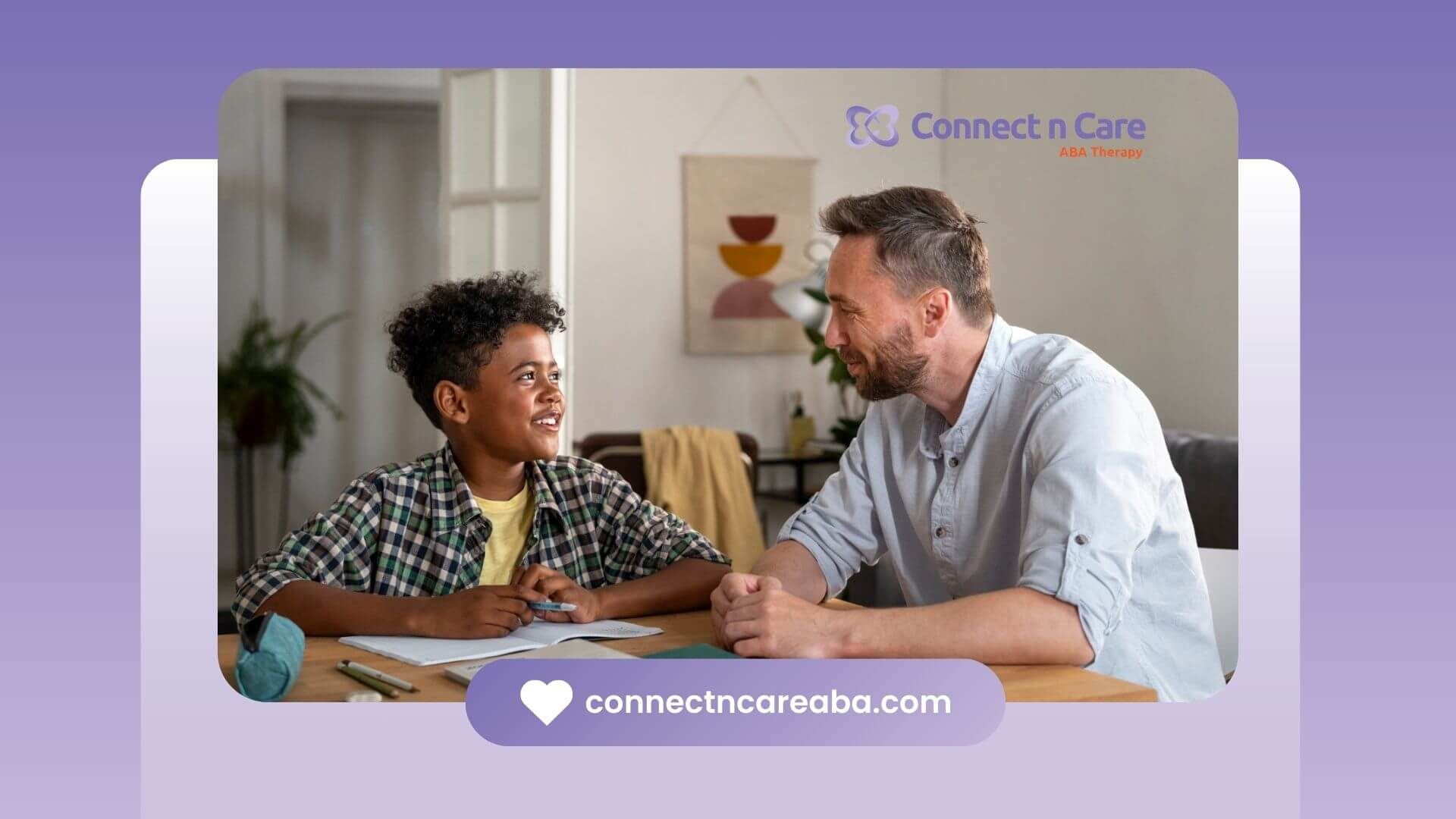 BCBA and boy with autism smiling and talking at a table in ABA therapy.