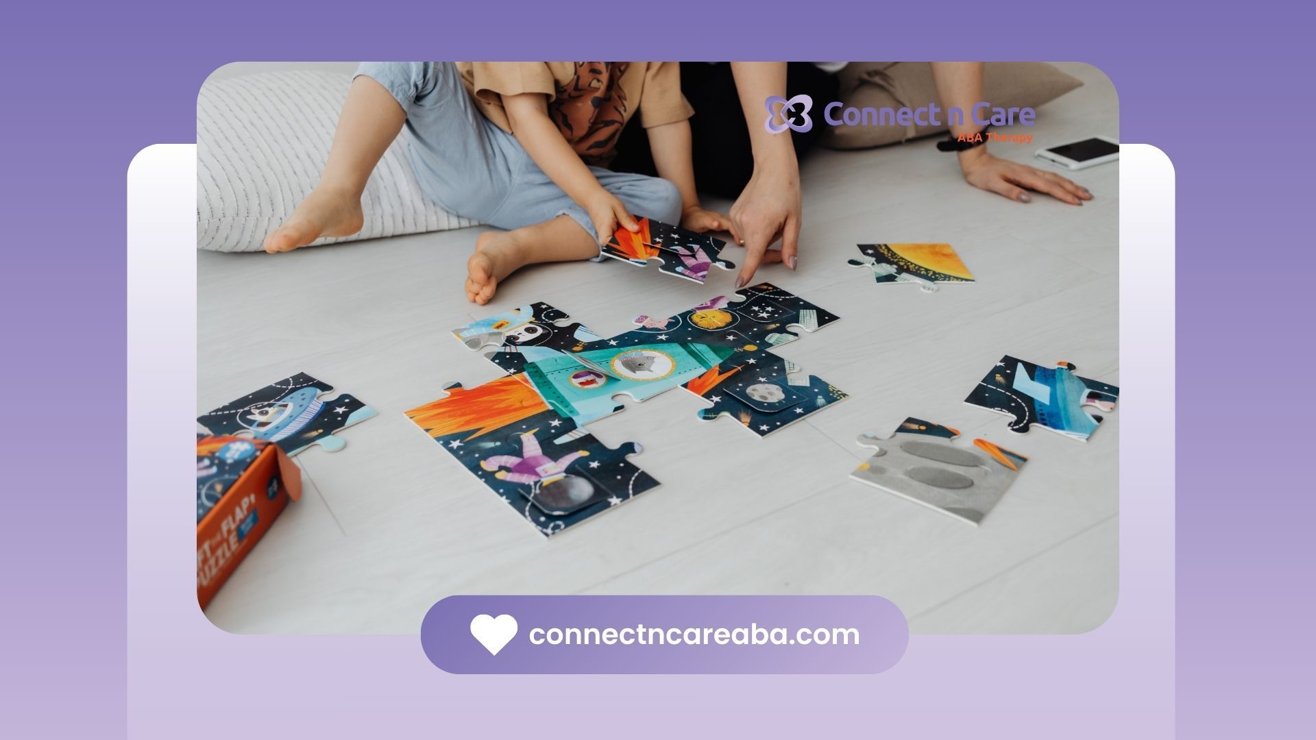 Two people putting together a puzzle on the floor, surrounded by pieces of varying colors.