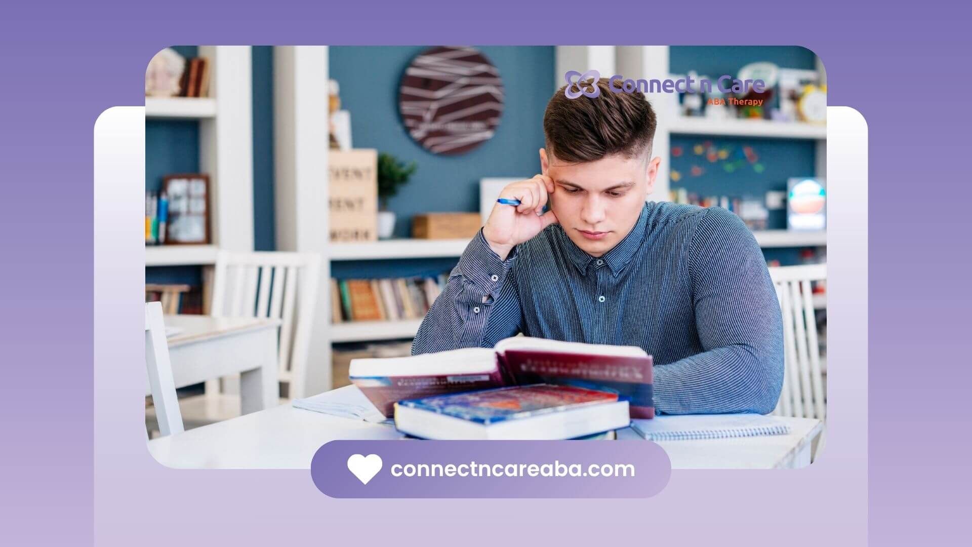 A focused young therapist studying with several books on a table, holding a pen and making notes
