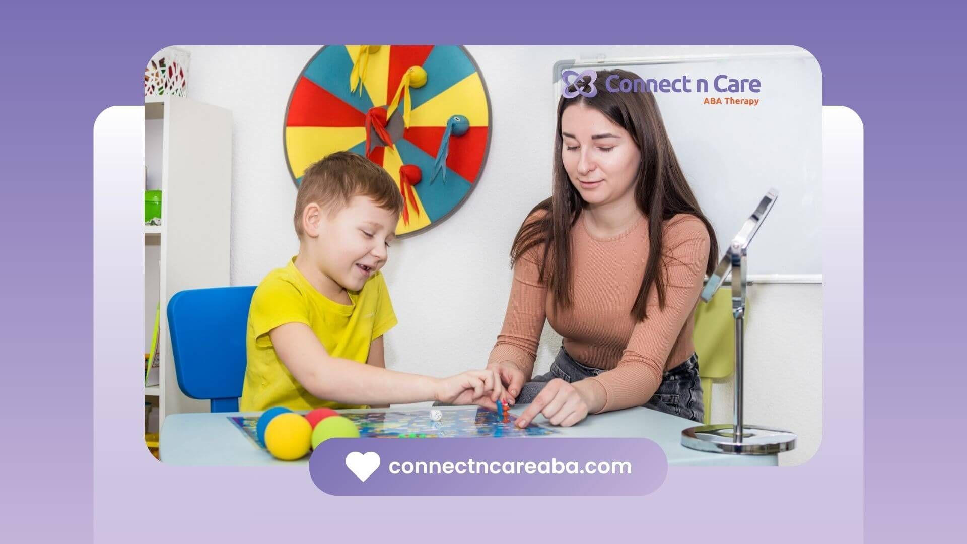 A boy and a woman working together on a puzzle, with balls & a wheel on the wall in the background.