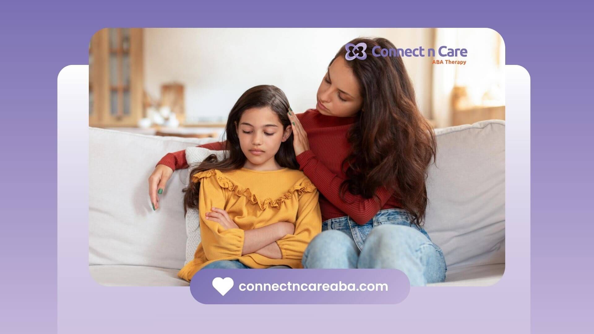 A BCBA comforts her young girl sitting on a couch during ABA therapy.