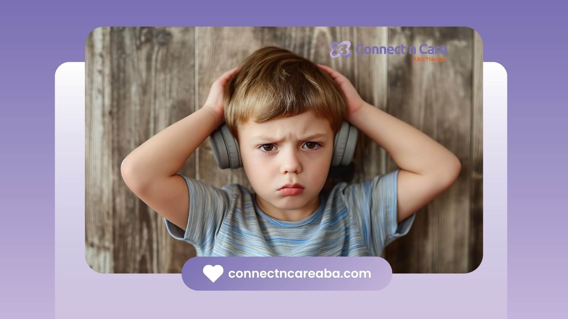 Young boy with autism holding headphones over his ears.