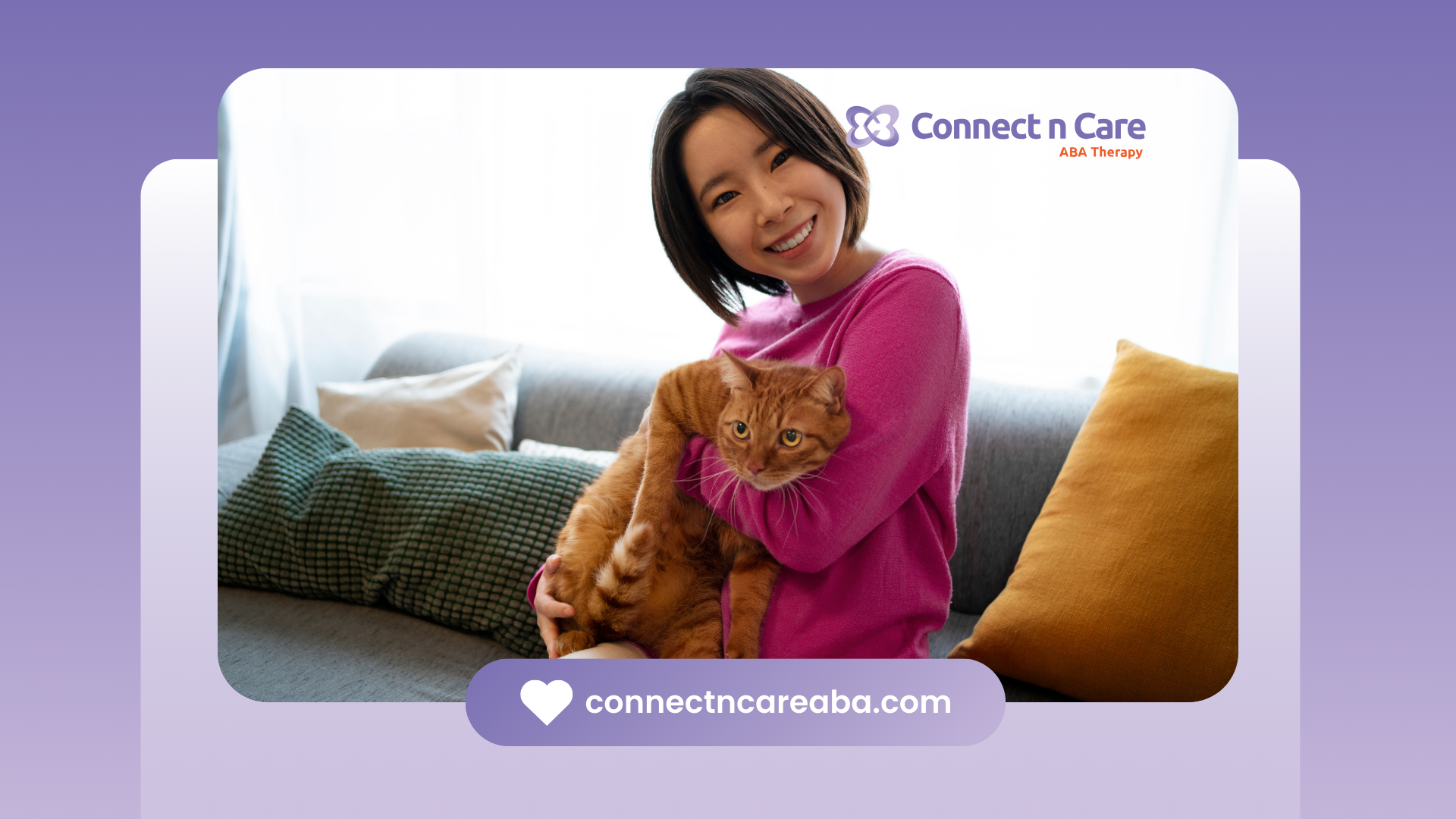 A woman is sitting on a couch holding a cat.