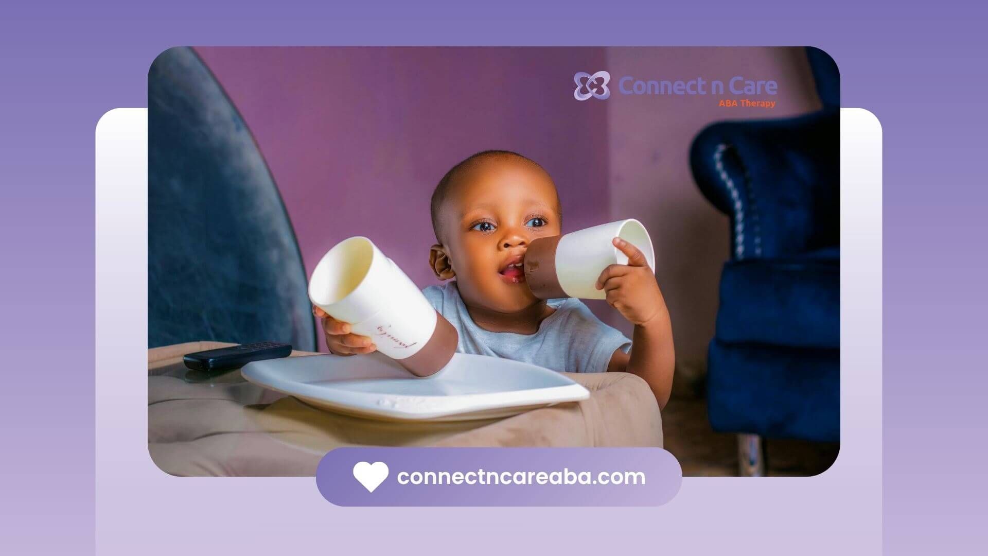 Autistic toddler sitting on a couch playing with two cups near a white plate after ABA therapy.