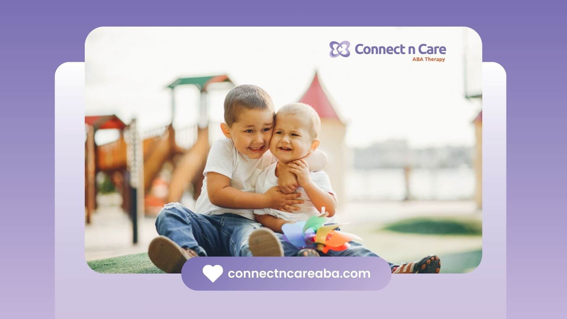 Two boys with autism hugging and smiling at a playground after ABA therapy.