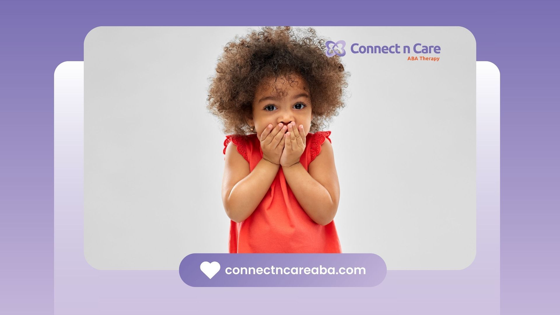 Young child in red dress covering mouth, surprised expression.
