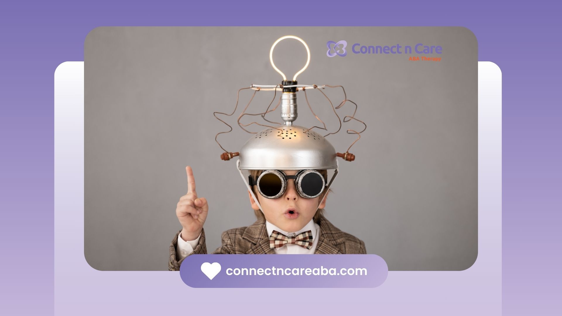 A young boy wearing a hat and goggles is pointing up.