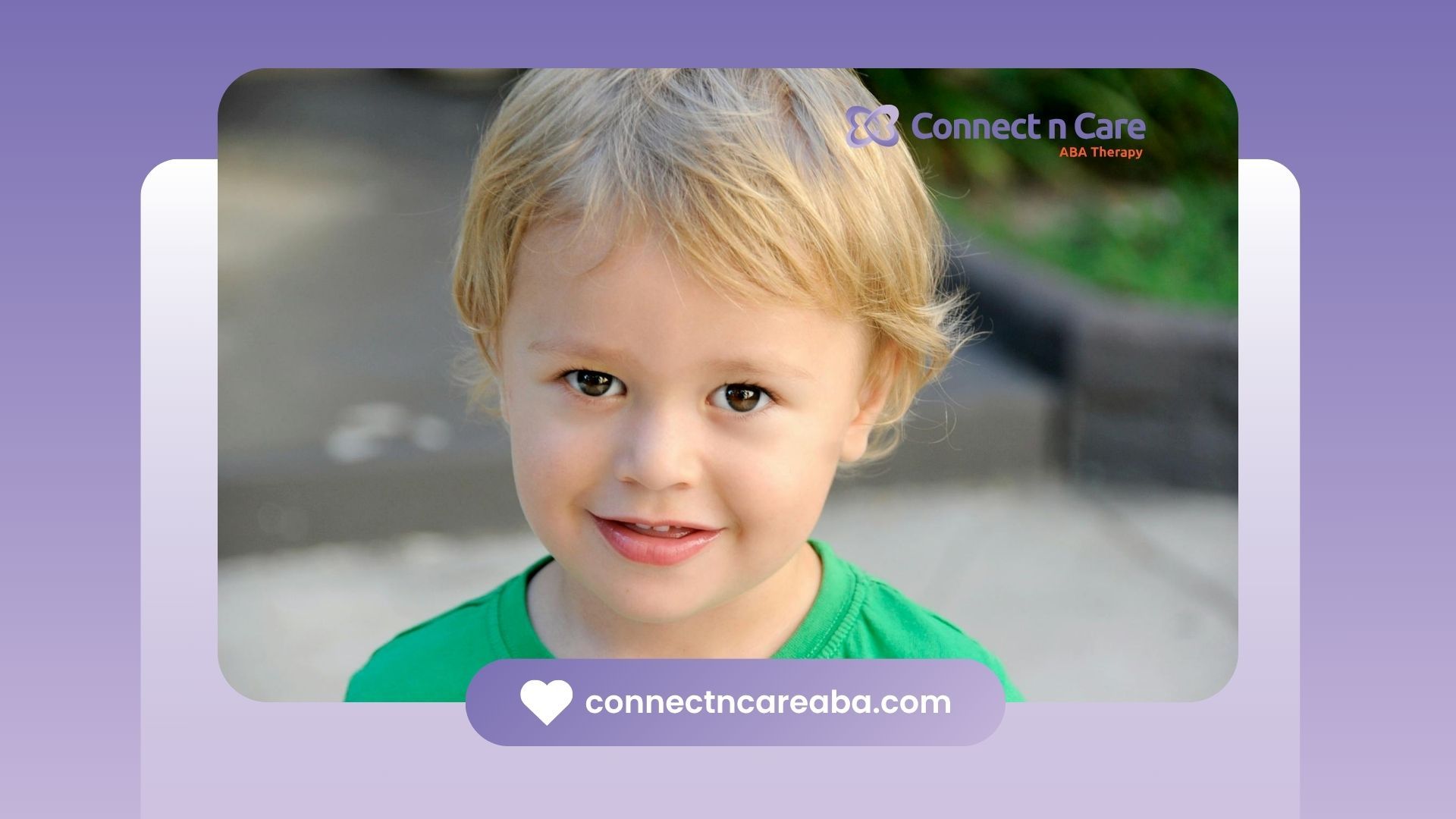 Smiling autistic toddler with blond hair wearing a green shirt during ABA therapy outdoors in NC.
