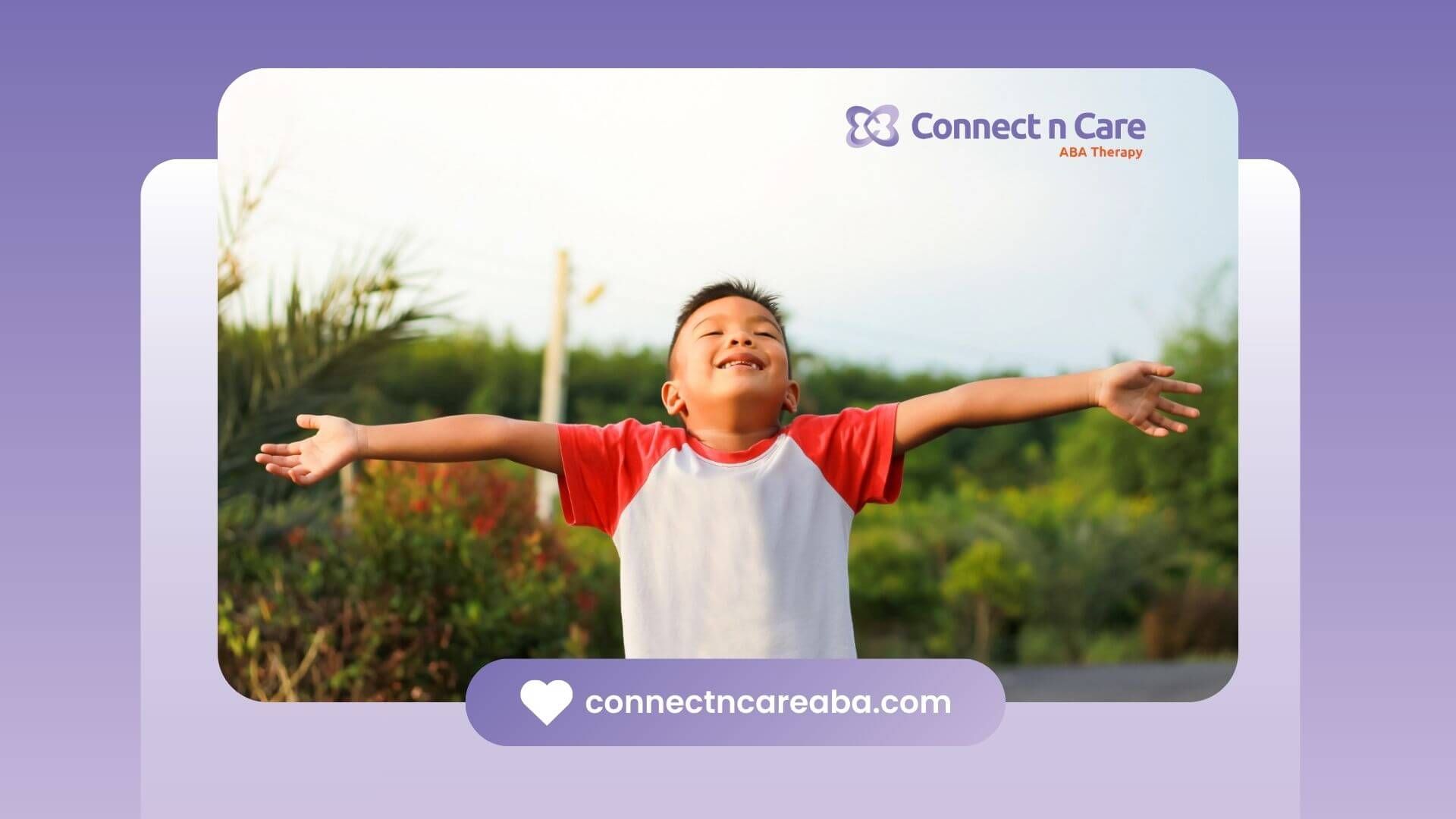 Young boy with autism outdoors with arms outstretched, smiling joyfully.