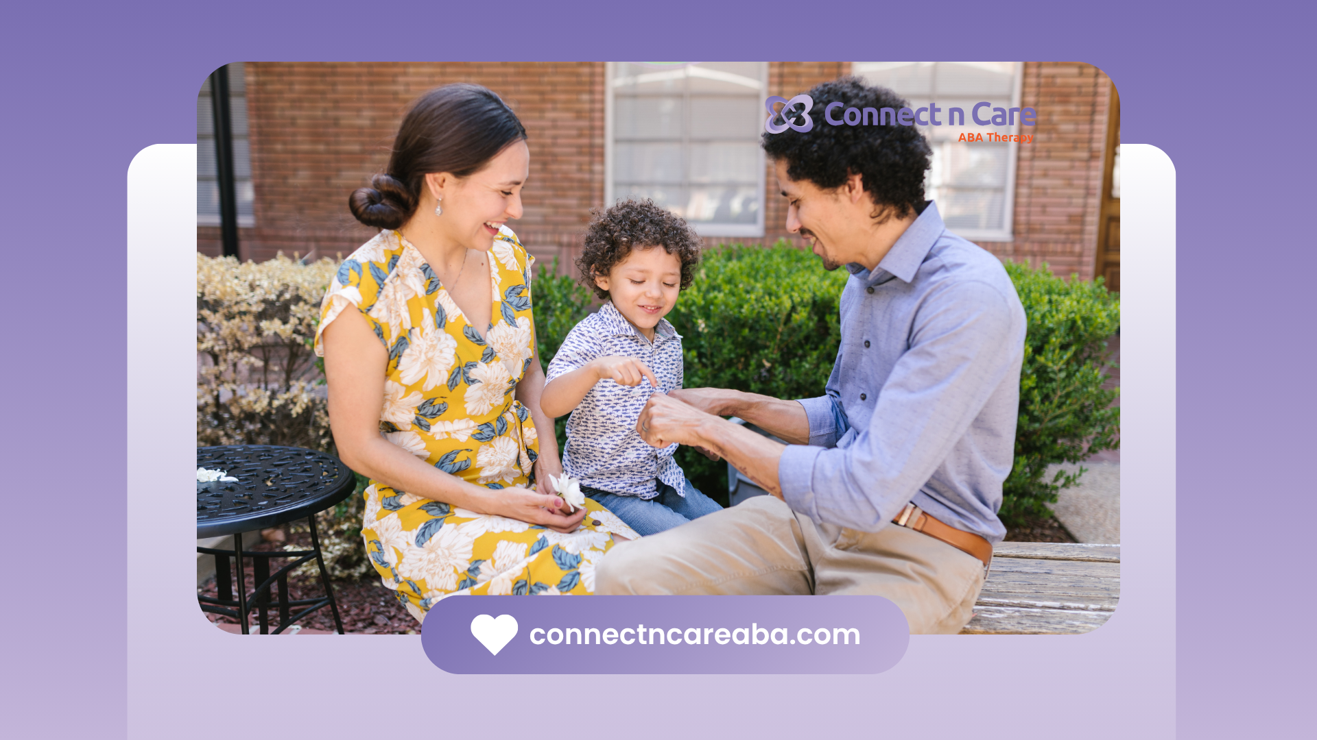 A man and a woman are sitting on the ground with a child.