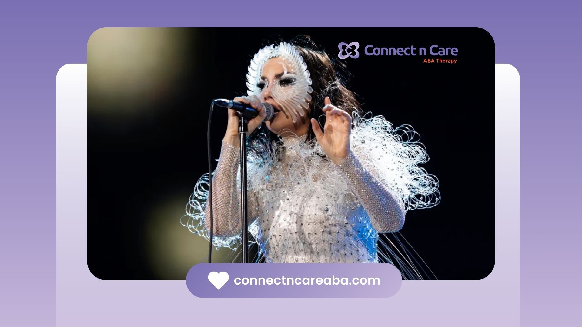 Bjork, suspected with autism, in a white costume with a spiky mask sings into a microphone in NC.