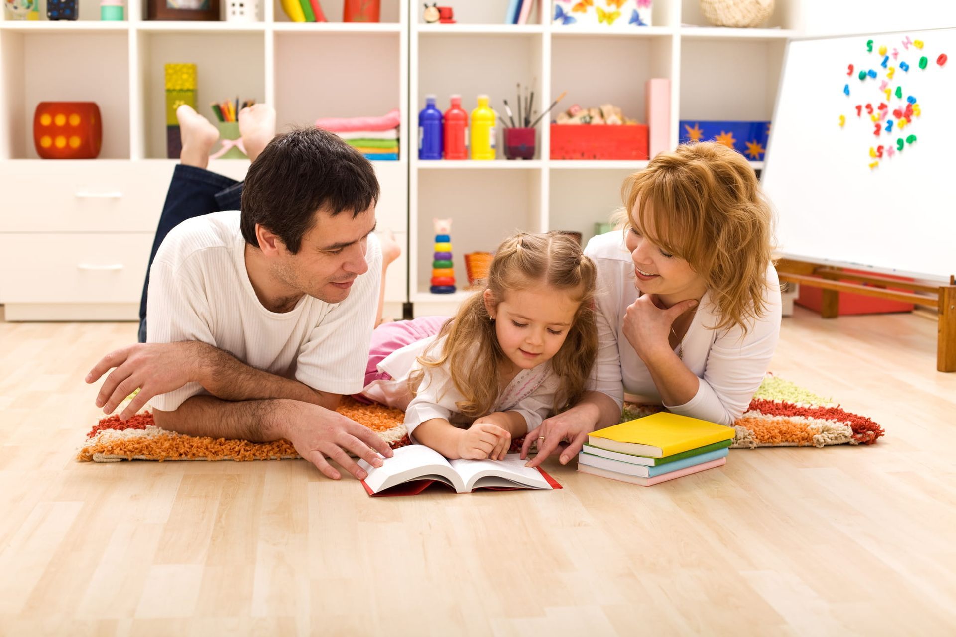 A woman sitting at a table with a young boy playing with wooden blocks 