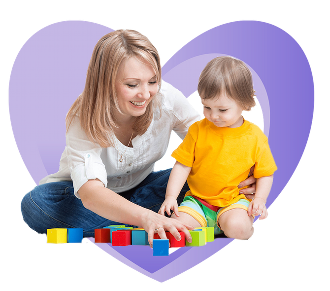 A woman and child are playing with blocks in front of a heart