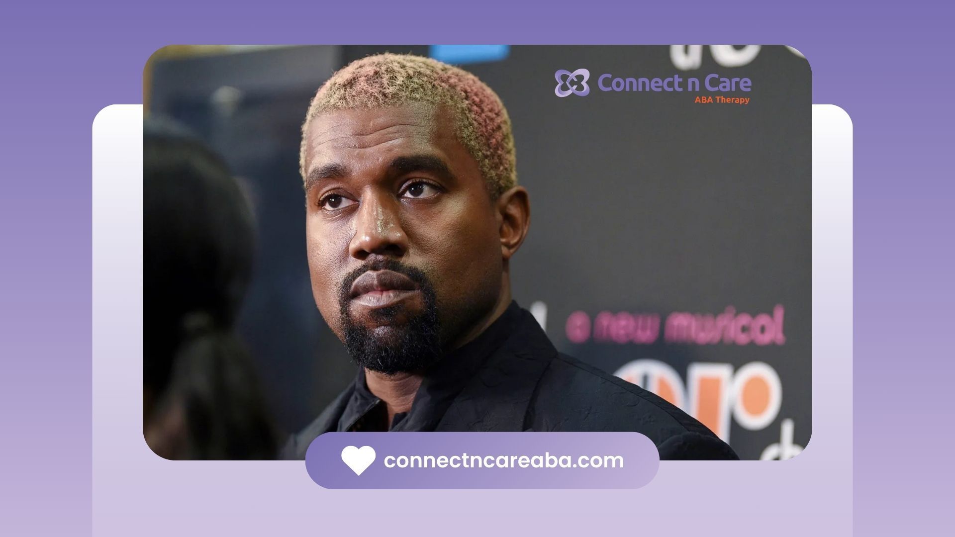 Kanye West with a beard and blonde hair is standing in front of a purple background.