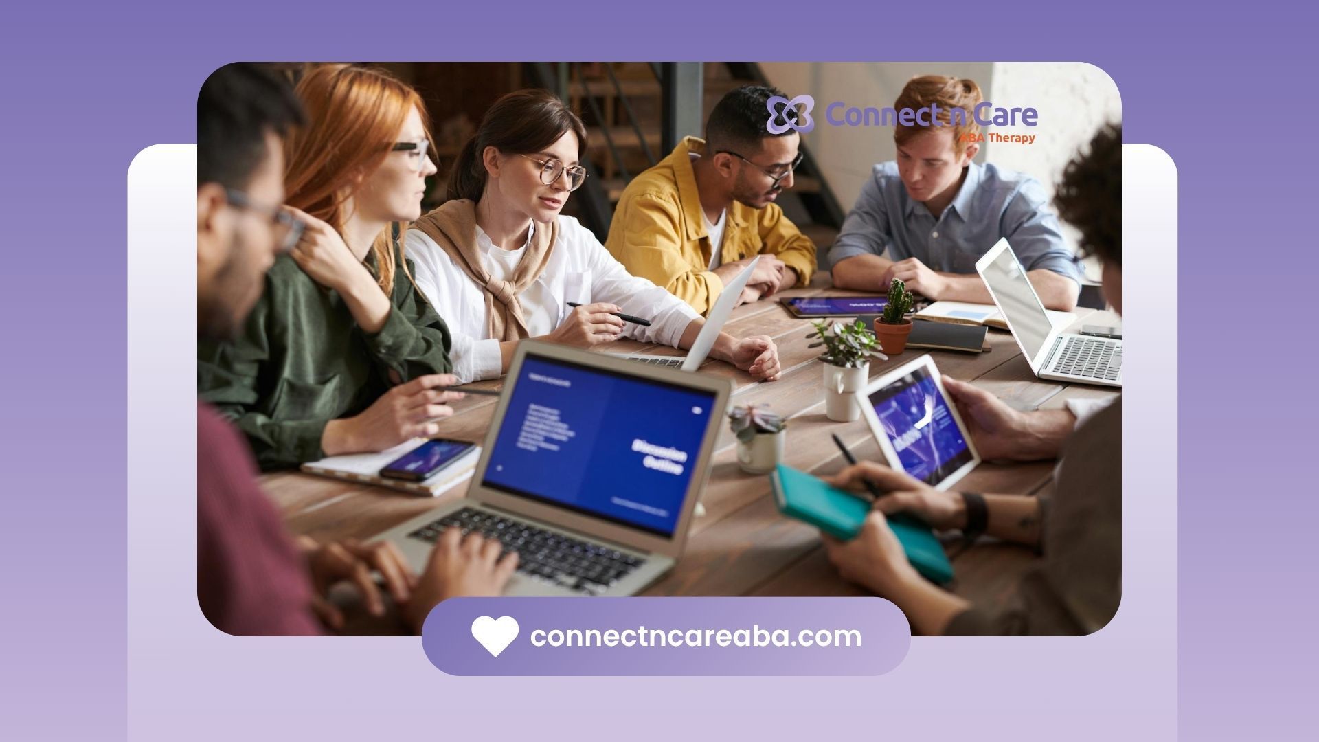 A team of autistic adults collaborating around a table with laptops and tablets in North Carolina.