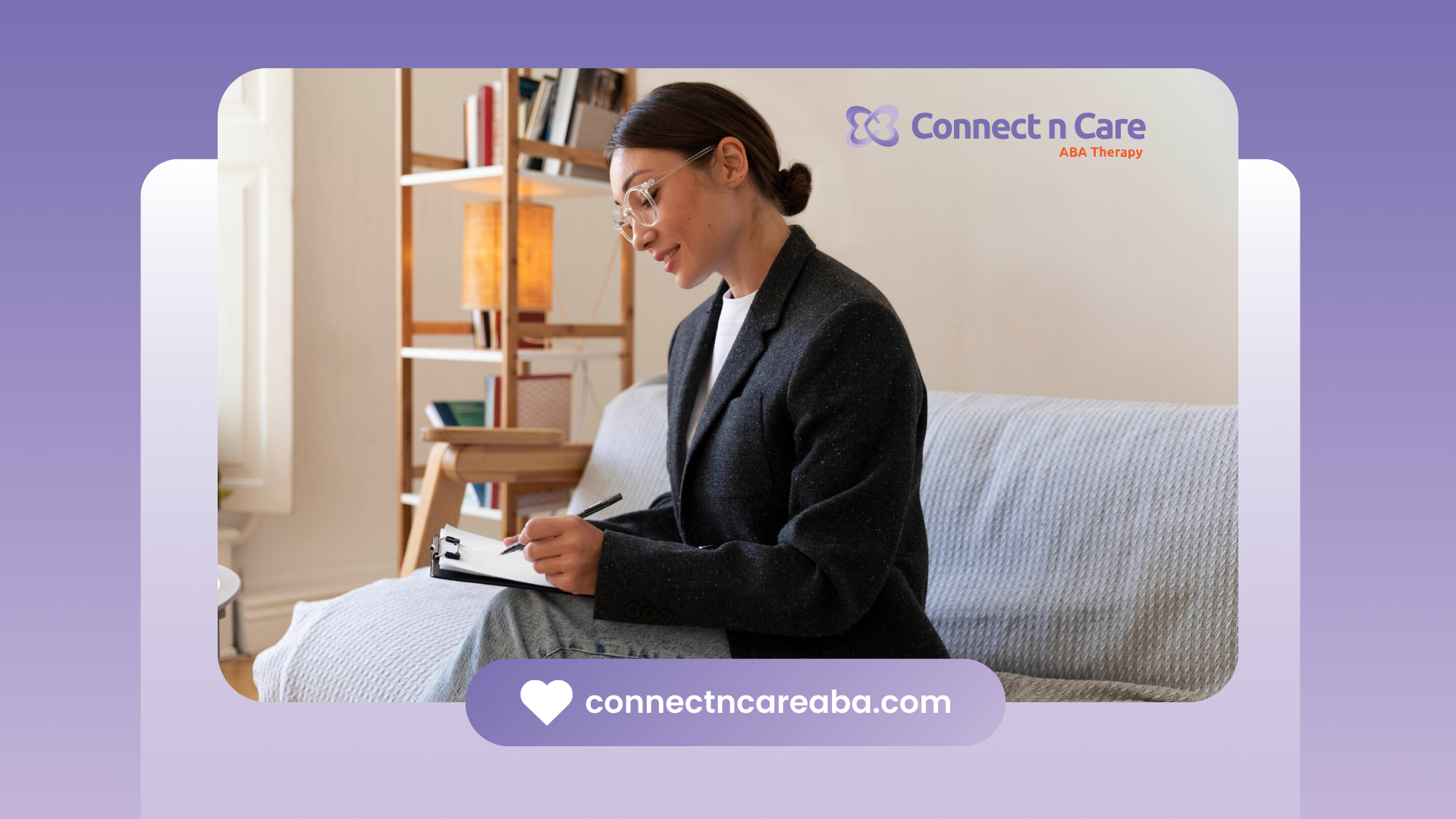 A BCBA is sitting on a couch, writing on a clipboard.