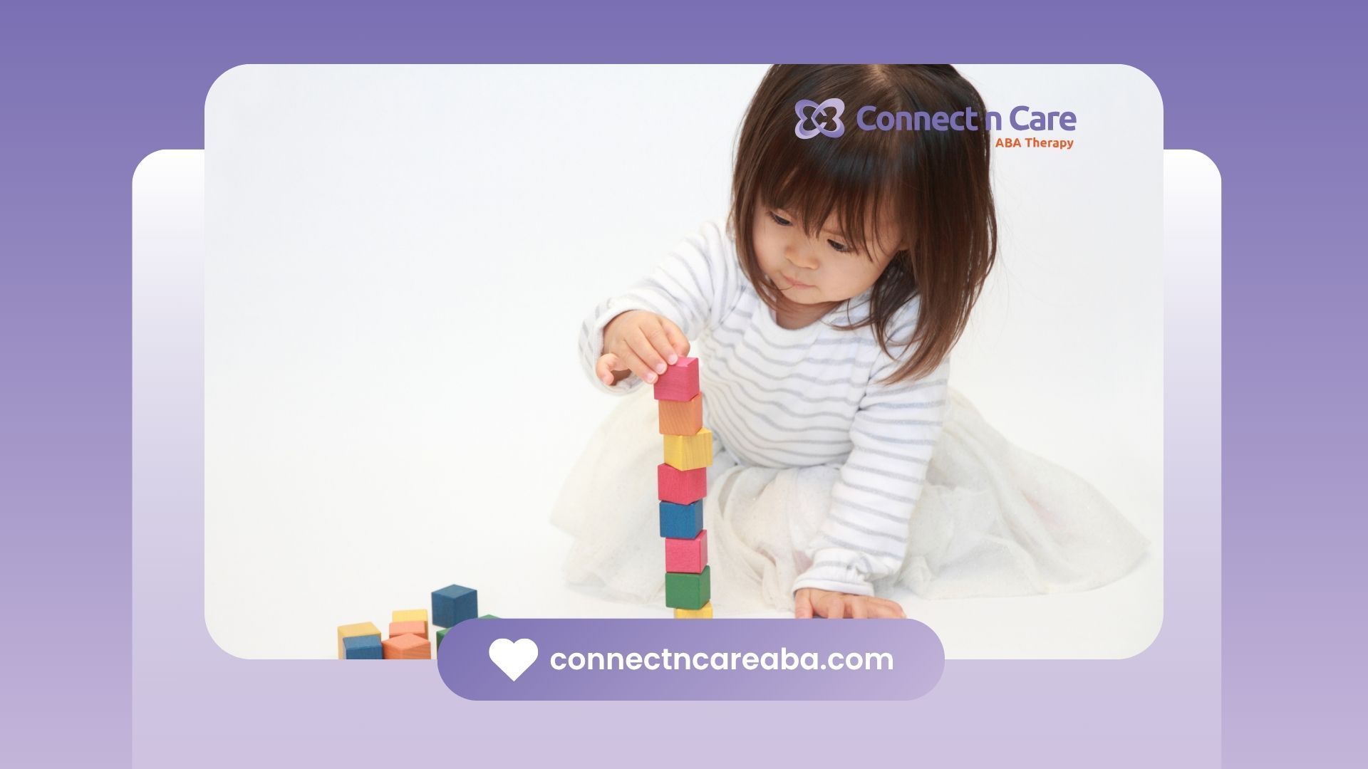 A little girl is playing with wooden blocks on the floor.
