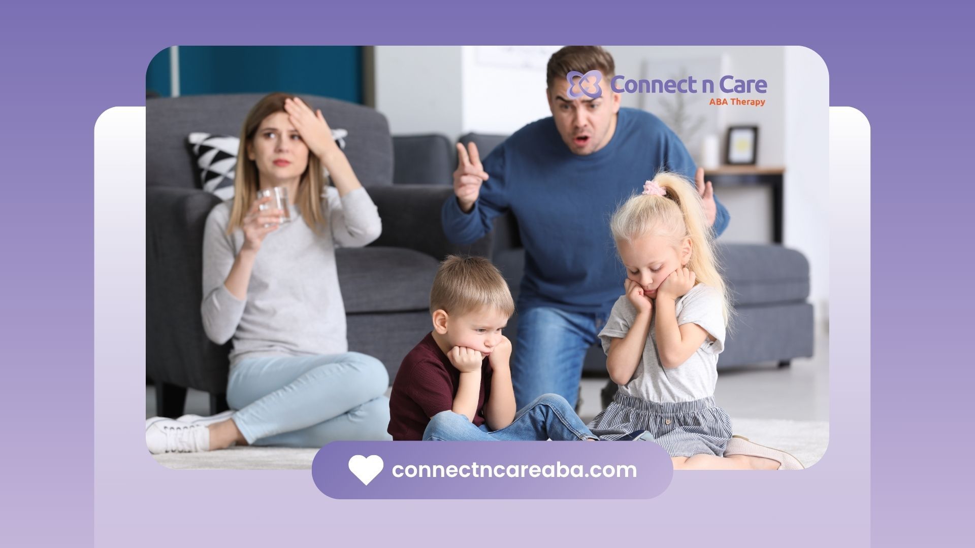 A family is sitting on the floor in a living room.
