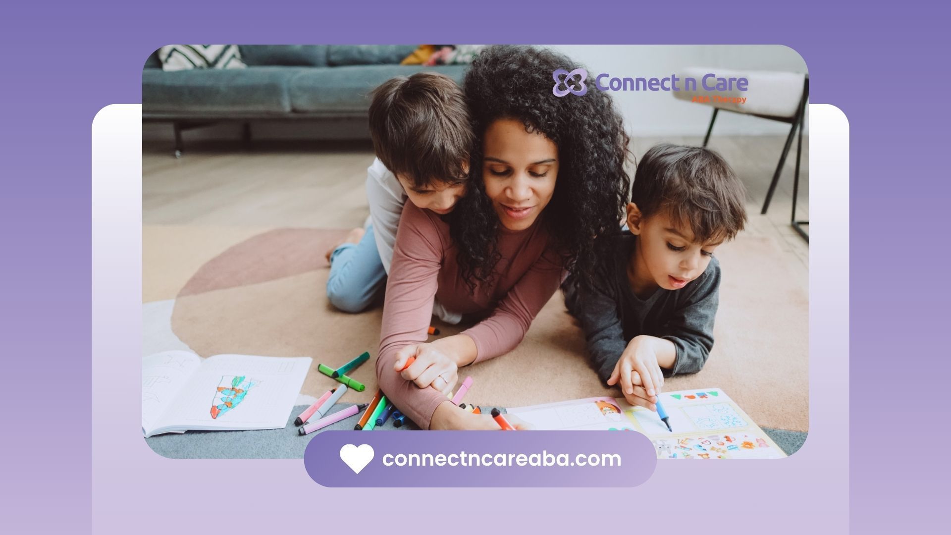 A woman is laying on the floor with two children.