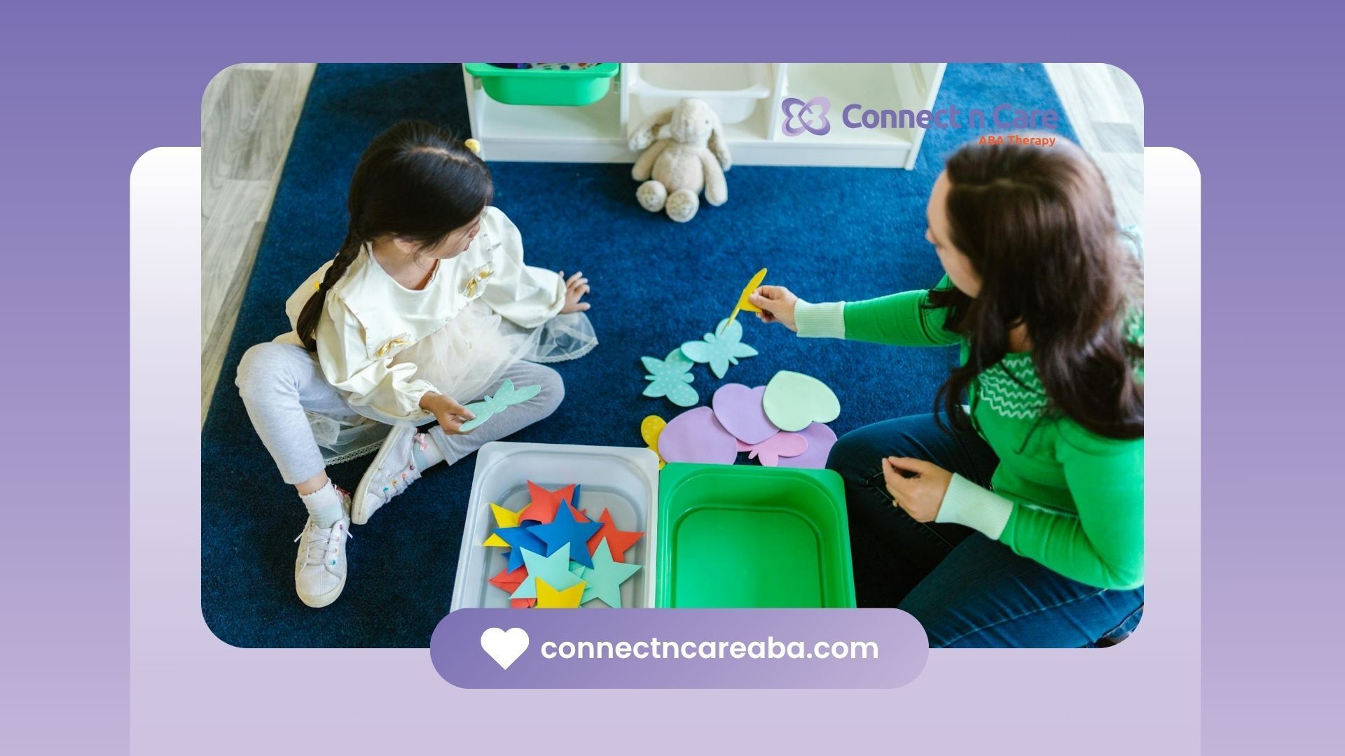 A BCBA and young autistic girl sitting on carpet sorting colorful paper shapes during ABA therapy.