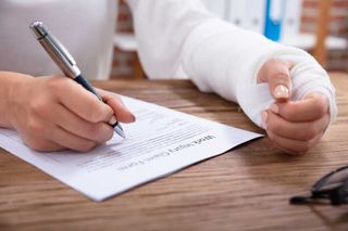 Injured Worker Signing Documents — Oak Harbor, OH — McKean & McKean