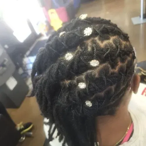 A woman with dreadlocks and rhinestones in her hair.