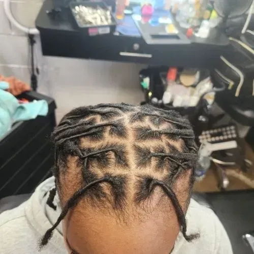 A woman with red hair is sitting in a chair in a salon.