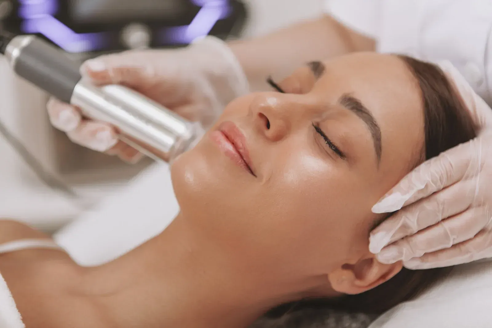 A woman is getting a facial treatment at a beauty salon.