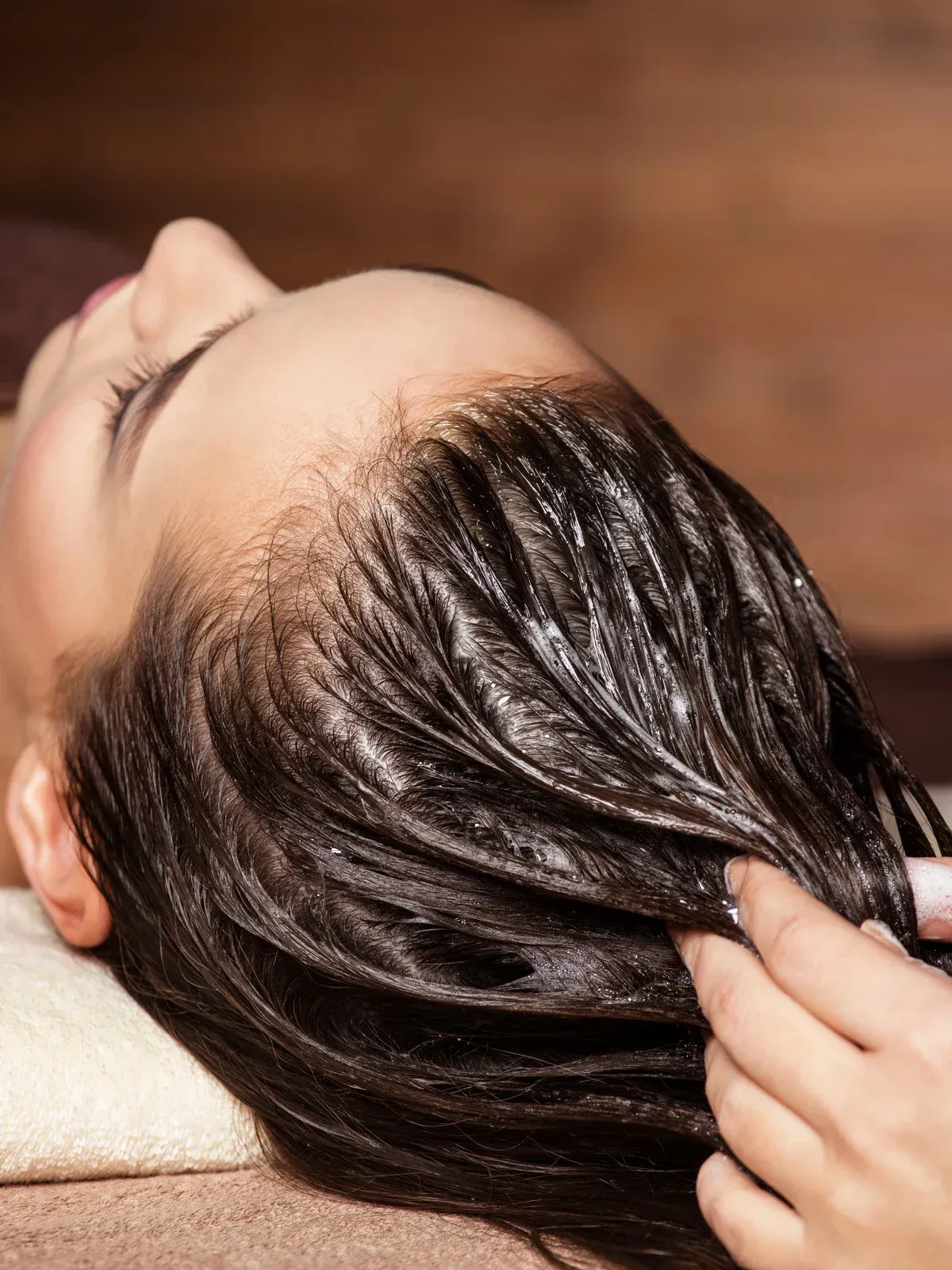 A woman is getting her hair washed at a salon.