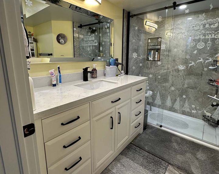 Beautiful remodeled bathroom with white vanity and white counter top