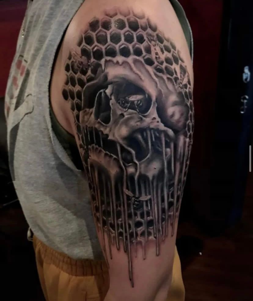 A man has a tattoo of a skull on his arm