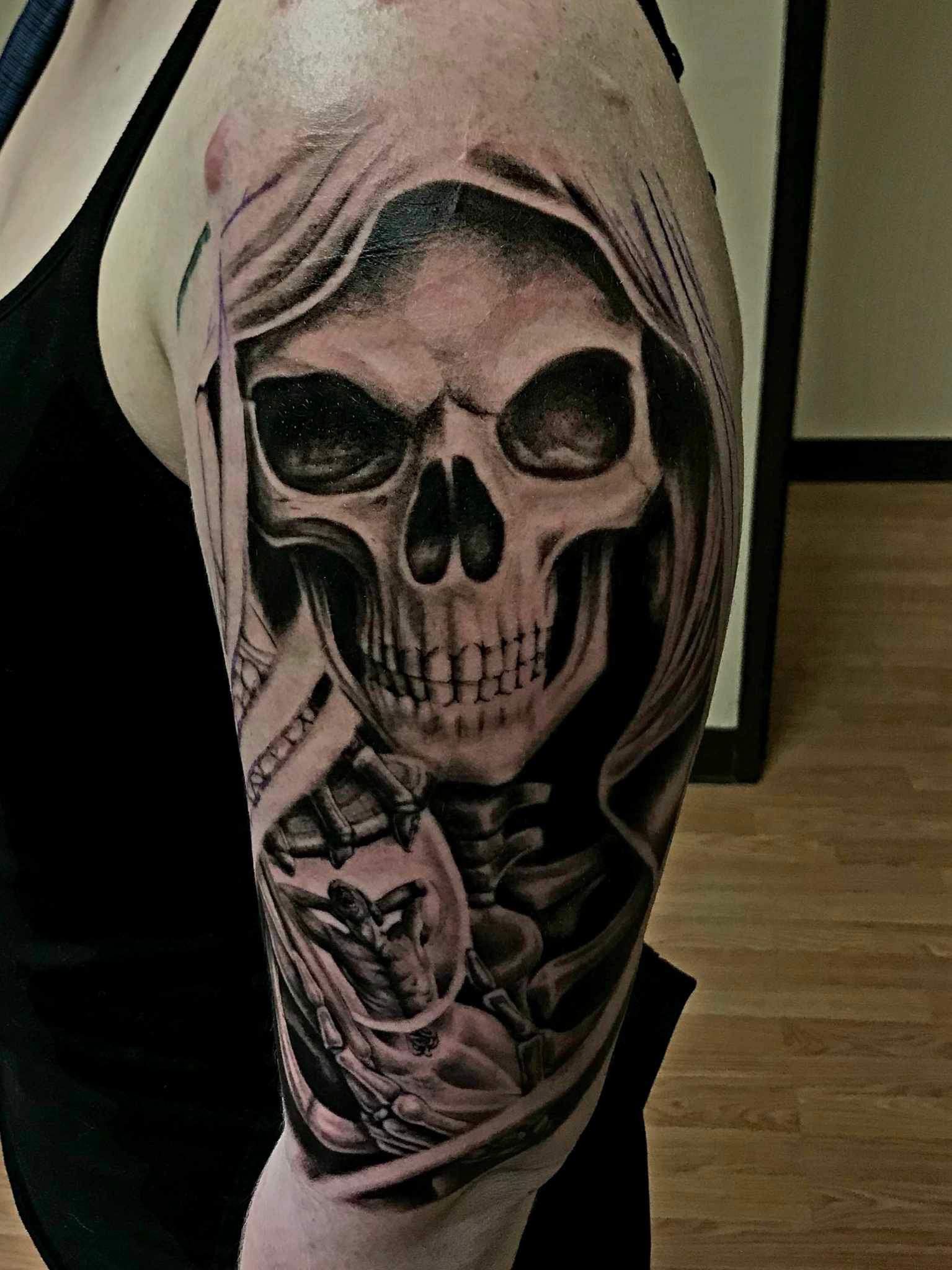 A woman has a grim reaper tattoo on her arm